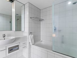 A bathroom with a sink and bathtub at The Old Barn in Auckland