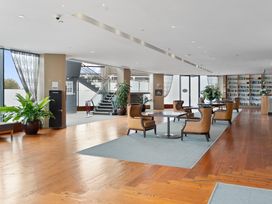 A lobby with seating and a bookshelf at The Old Barn in Auckland