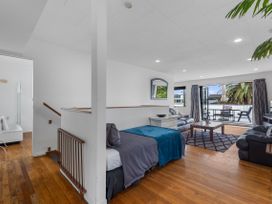 A living room with a bed and sofa at Papamoa Beach in Papamoa