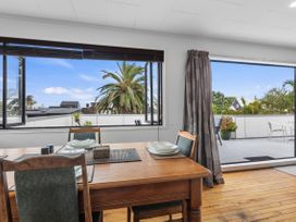 A dining room with a table and chairs at Papamoa Beach, Papamoa