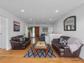 A living room with sofas and a coffee table at Papamoa Beach in Papamoa
