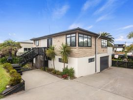 A house with stairs and landscaping at Papamoa Beach in Papamoa