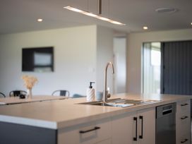 A kitchen with a sink and faucet at Te Anau Holiday Home in Te Anau