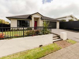 A house with a driveway and garden at New Plymouth
