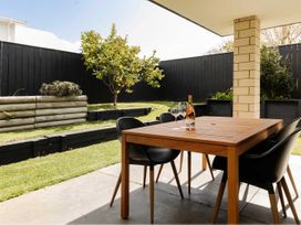 A dining table with chairs in an outdoor area at New Plymouth