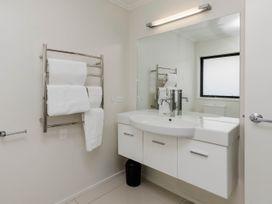 A bathroom with towels on a rack and a sink at New Plymouth
