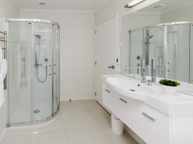 A bathroom featuring a shower and washbasin at New Plymouth in New Plymouth