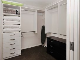 A closet with shelves and a dresser at New Plymouth