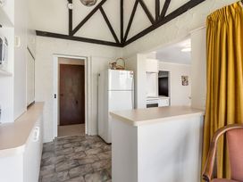 A kitchen with a refrigerator and counter at Whangamata in Whangamata