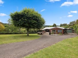 An outdoor area with a house and tree at Paradise At 471 - Rotorua Holiday Home, Rotorua