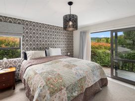 A bedroom with a bed and window at Paradise At 471 - Rotorua Holiday Home, Rotorua