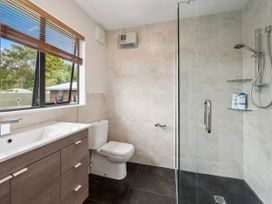 A bathroom with a sink, toilet, and shower at Paradise At 471 - Rotorua Holiday Home in Rotorua
