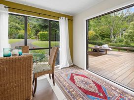 A dining room with a glass table and chairs at Paradise At 471 - Rotorua Holiday Home in Rotorua
