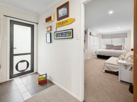 A hallway with a door leading to a bedroom at Paradise At 471 - Rotorua Holiday Home