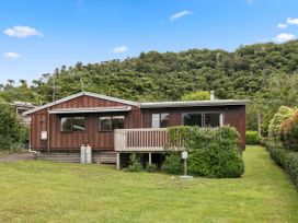 A house with a garden and deck at Paradise At 471 - Rotorua Holiday Home, Rotorua