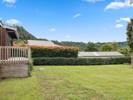 An outdoor area with a lawn and deck at Paradise At 471 - Rotorua Holiday Home, Rotorua