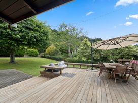 An outdoor deck area with furniture and greenery at Paradise At 471 - Rotorua Holiday Home in Rotorua