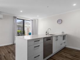 A kitchen with a sink and dishwasher at Papamoa