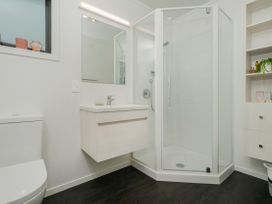 A bathroom with a shower, sink, and toilet at Whitianga