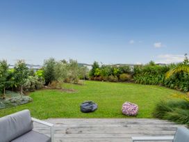 A garden area with grass and plants at Whitianga