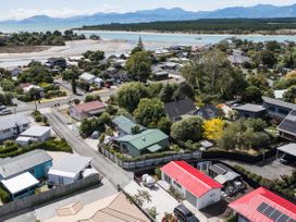 An aerial view of houses and a river at Casa Verde - Mapua Holiday Home, Mapua