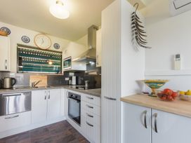 A kitchen with a countertop, sink, and appliances at Casa Verde - Mapua Holiday Home in Mapua