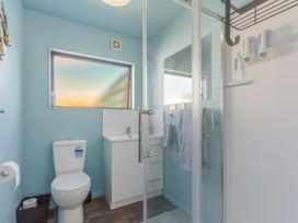 A bathroom with a toilet, sink, and shower at Casa Verde - Mapua Holiday Home in Mapua