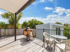 An outdoor space with a barbecue and table at Casa Verde - Mapua Holiday Home in Mapua