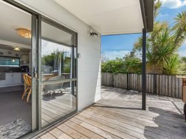 An outdoor deck with a door leading inside at Casa Verde - Mapua Holiday Home, Mapua