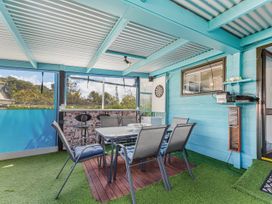 A patio with a table and chairs at Casa Verde - Mapua Holiday Home, Mapua