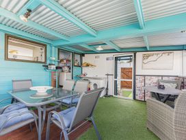 An outdoor area with a table and chairs at Casa Verde - Mapua Holiday Home, Mapua
