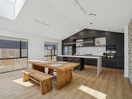 A kitchen with a table and benches at Cromwell Holiday Home in Cromwell