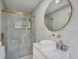 A bathroom with a shower and sink at Cromwell Holiday Home in Cromwell
