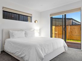 A bedroom with a bed and window at Sunrise on Vintage - Cromwell Holiday Home Cromwell