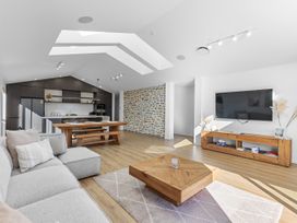 A living room with a sofa and coffee table at Sunrise on Vintage - Cromwell Holiday Home in Cromwell