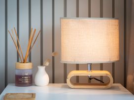 A lamp and decorative items on a table at Clyde Holiday Home in Clyde