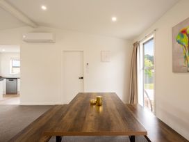A dining room with a wooden table and candles at Clyde Holiday Home in Clyde