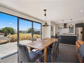 A dining room with a table and chairs at Dancing Tussock Escape - Cromwell
