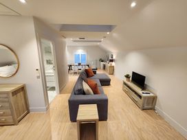 A living room with a sofa and television at Studio - Point Wells Holiday Home, Point Wells