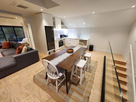 A kitchen and dining area with a table and chairs at Studio - Point Wells Holiday Home Point Wells