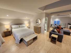 A bedroom with a bed and seating area at Studio - Point Wells Holiday Home in Point Wells