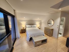 A bedroom with a bed and dresser at Studio - Point Wells Holiday Home in Point Wells