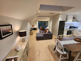 A living room with a sofa and a dining table at Studio - Point Wells Holiday Home in Point Wells