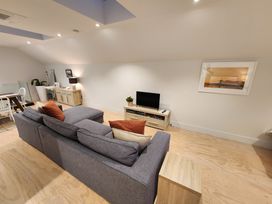 A living room with a sofa and TV at Studio - Point Wells Holiday Home in Point Wells