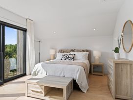 A bedroom with a bed and dresser at The Coastal Studio - Point Wells Holiday Home