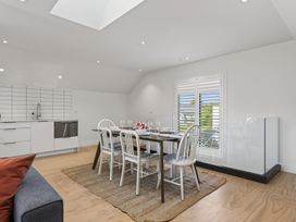 A dining room with a table and chairs at The Coastal Studio - Point Wells Holiday Home Point Wells