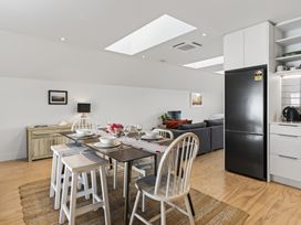 A dining room with a table and chairs at The Coastal Studio - Point Wells Holiday Home Point Wells