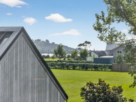 A view of a grassy area with trees and houses at The Coastal Studio - Point Wells Holiday Home Point Wells
