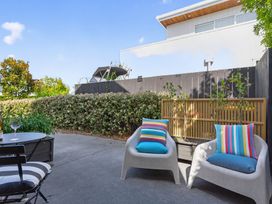 An outdoor seating area with two chairs and a table at The Coastal Studio - Point Wells Holiday Home in Point Wells