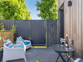 An outdoor patio with chairs and a table at The Coastal Studio - Point Wells Holiday Home in Point Wells